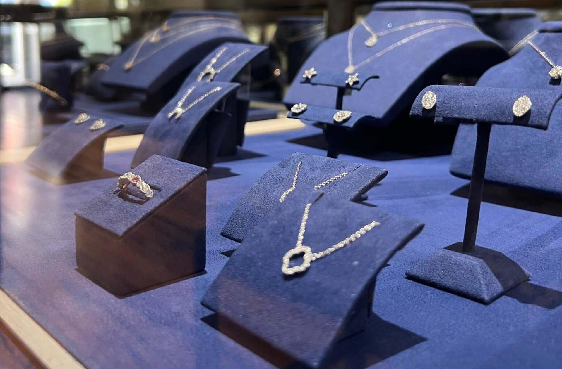 Jewelry Shop Case with diamond jewelry necklaces, rings, and earrings.